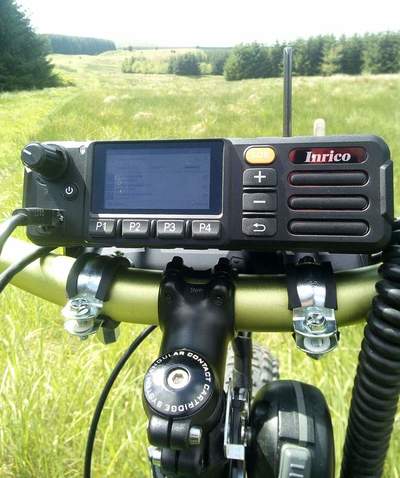 Inrico TM-7 network radio 'mountain bike mobile' secured to handlebars using 'pipe clamps' with rubber sleeves.
